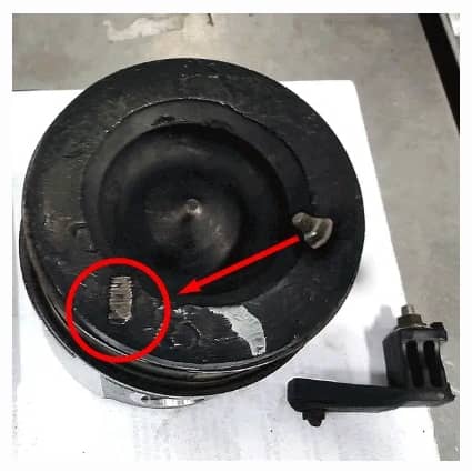 Image shows a picture of the Dodge Cummins 6.7L Liter engine damage from the stock air intake heater grid's stud and nut which over time can come loose and drop into the number 6 cylinder and cause engine damage or failure; prevent failure and engine damage with the Banks Monster-Ram intake heater upgrade.