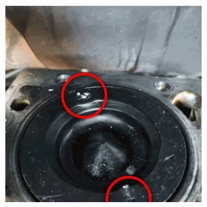 Image shows a picture of the Dodge Cummins 6.7L Liter engine damage from the stock air intake heater grid's stud and nut which over time can come loose and drop into the number 6 cylinder and cause engine damage or failure; prevent failure and engine damage with the Banks Monster-Ram intake heater upgrade.